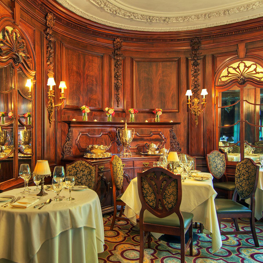 An elegant dining room with well appointed tables and fine decor