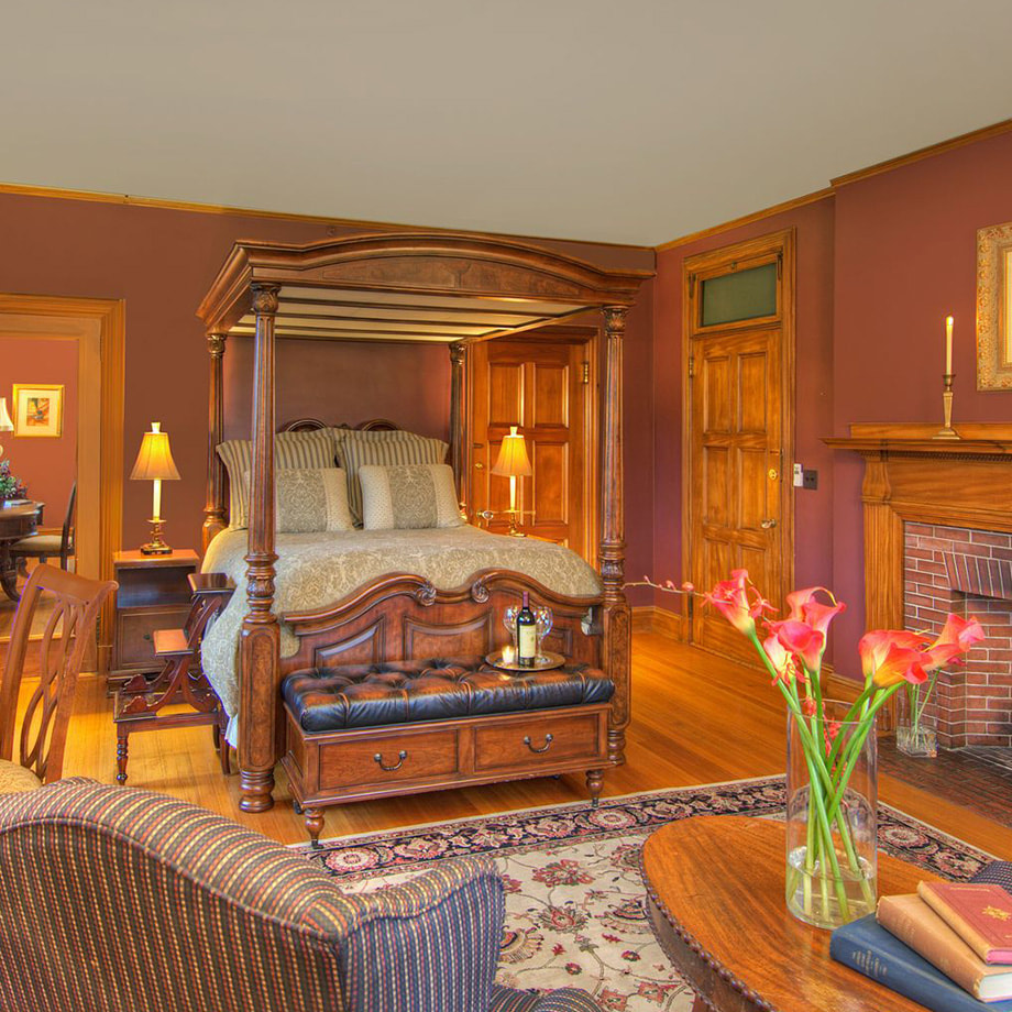 A large suite with elegant furnishings and a king bed 
